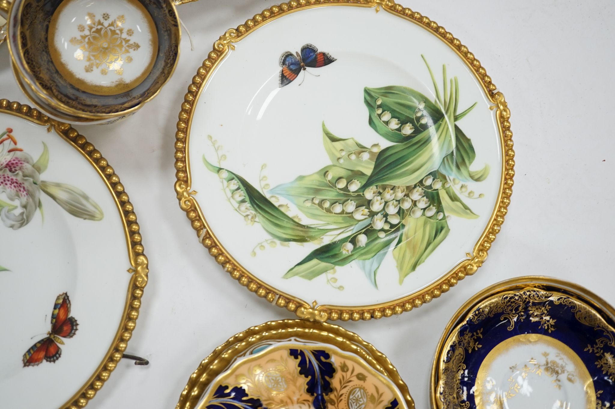 A small collection of Victorian porcelain tea cups and saucers and sundry dessert plates